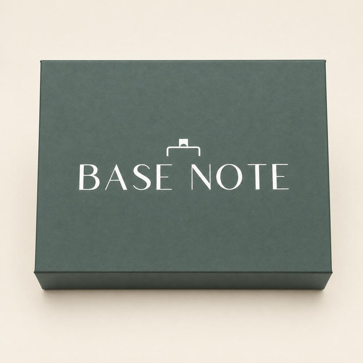 Closed Base Note gift box in sage green with the white Base Note wordmark